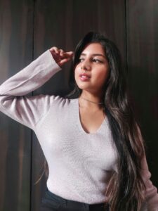 Ritu Biswas styling v-neck purple sweater in her fashion and lifestyle blog
