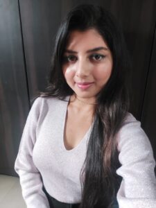 Ritu Biswas styling v-neck purple sweater in her fashion and lifestyle blog