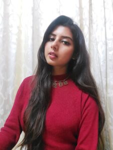 Ritu Biswas styling high neck red sweater in her fashion and lifestyle blog
