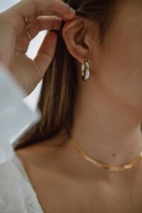 girl wearing hoop earrings in a blog post of 9 must have jewelry for everyday wear