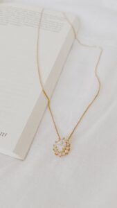 A simple gold necklace with a pendant in a blog post of 9 must have jewelry for everyday wear