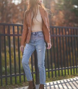 Woman wearing high rise jeans/trouser with brown jacket in fashion and lifestyle blog by Ritu Biswas with the topic 11 summer fashion trends that are easy to follow