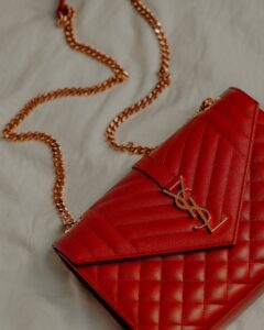 Red YSL bag with golden metal straps in fashion and lifestyle blog by Ritu Biswas with the topic 11 summer fashion trends that are easy to follow