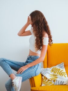 Woman wearing white crop top with blue jeans in fashion and lifestyle blog by Ritu Biswas with the topic 11 summer fashion trends that are easy to follow