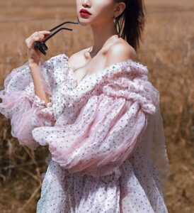 Woman wearing white top with statement sleeves in fashion and lifestyle blog by Ritu Biswas with the topic 11 summer fashion trends that are easy to follow