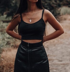 Woman wearing black spaghetti top and black solid skirt in "6 ways to style spaghetti tops" Woman wearing black spaghetti top and black solid skirt in "6 ways to style spaghetti tops"