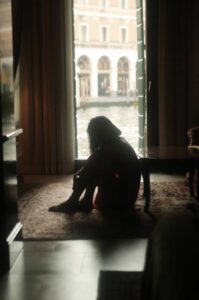 woman sitting alone pondering in the blog Why Self-Care Is Important And 6 Habits To Implement For A Healthy Lifestyle by Ritu Biswas