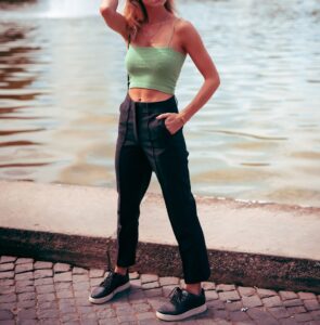 Woman wearing green spaghetti top and black straight pants in "6 ways to style spaghetti tops" Woman wearing green spaghetti top and black straight pants in "6 ways to style spaghetti tops"