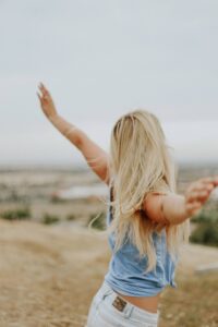 woman feeling liberated in the blog Why Self-Care Is Important And 6 Habits To Implement For A Healthy Lifestyle by Ritu Biswas